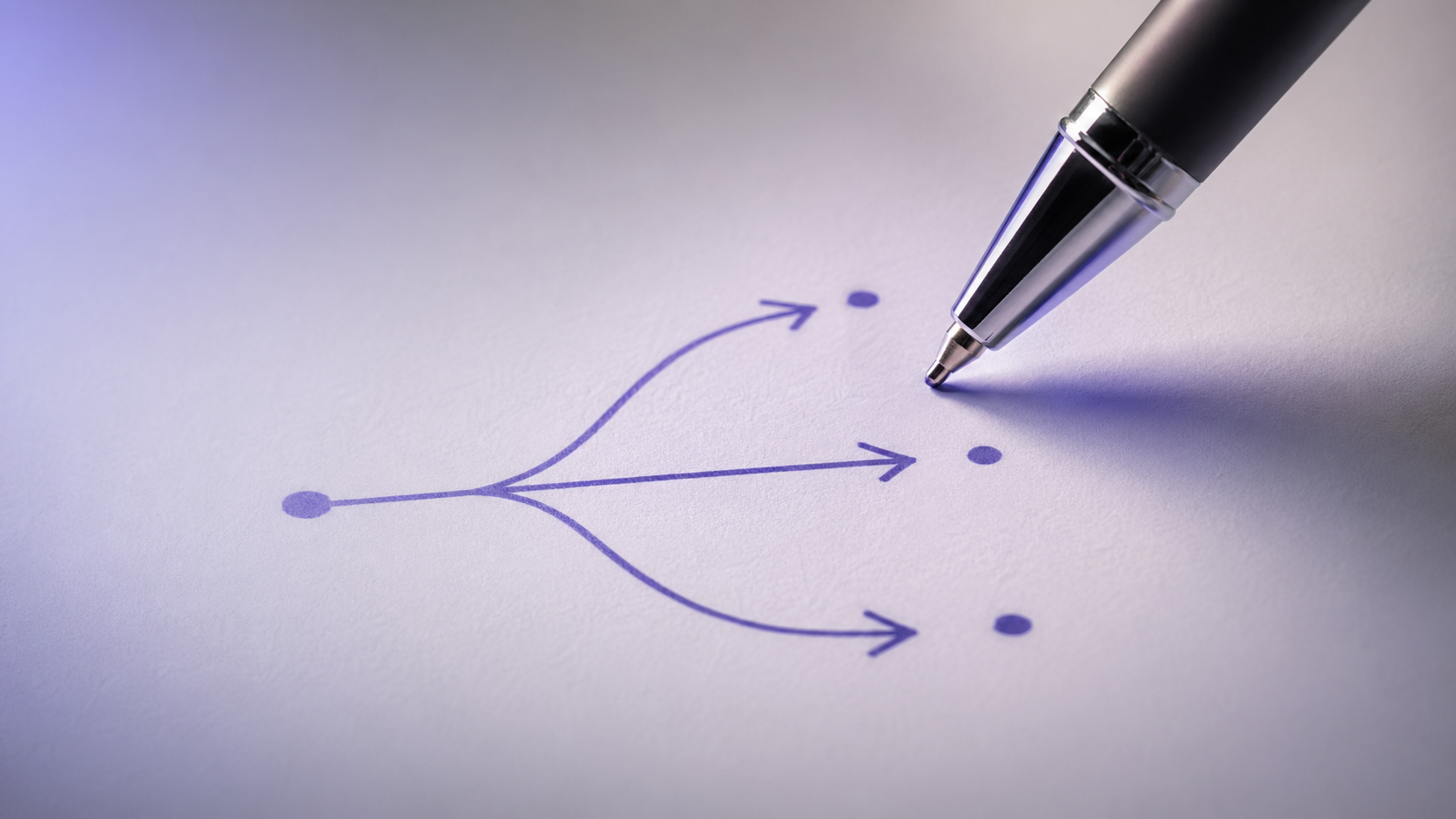 A pen poised over a sheet of paper showing a simple flowchart of branching arrows, illustrating the decision matrix for picking the right membership site software.